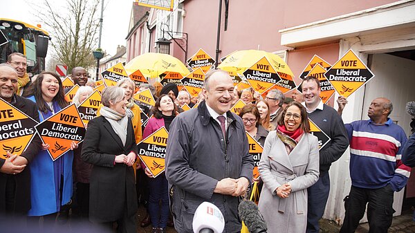 Ed Davey in front of crowd with Lib Dem diamond signs
