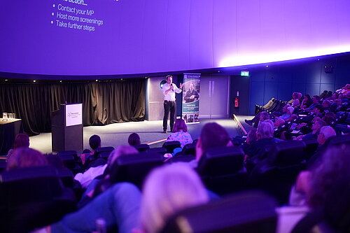 Danny speaking to the audience at Intech